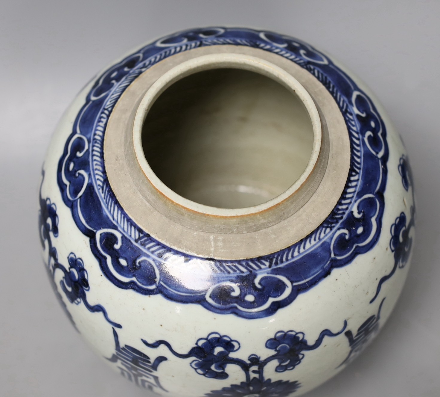 An 18th century Chinese blue and white jar, painted with ‘shou’, flowers and tendrils, 22cm high
